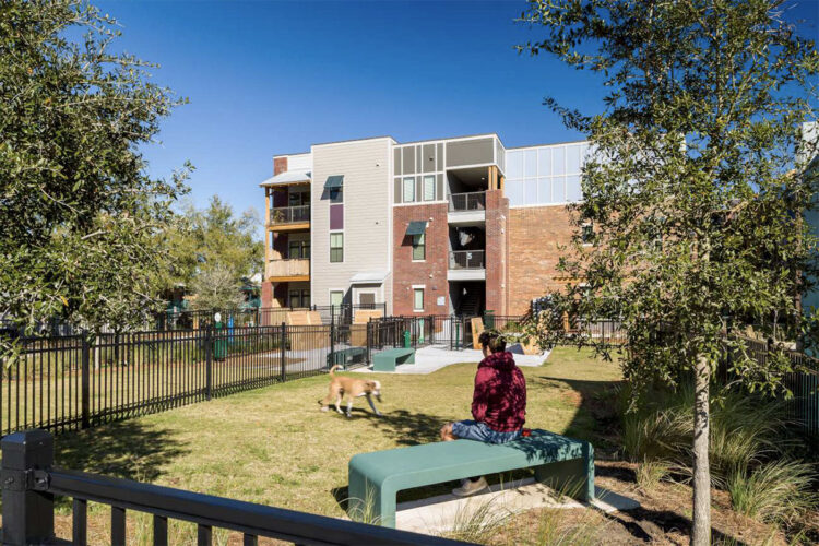 Resident enjoying green space with their pet