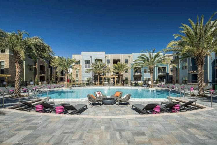 Outdoor lounge featuring a pool and fire pit